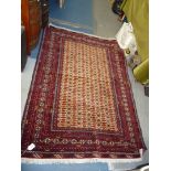 A burgundy and cream rug with fringing. 6' x 50".