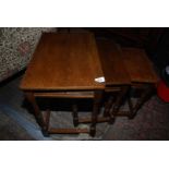 A nest of three dark Oak occasional Tables.