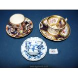 A Crown Derby Imari coffee can and saucer, mark to base and a blue and white Meissen cup and saucer,