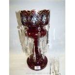A ruby glass lustre, decorated with floral motifs and gilt detail, scalloped edge, 15" tall (incl.