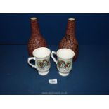 Two Crown Staffordshire Royal Wedding mugs and a pair of Vietnam 'Dona' vases, 9 1/2'' tall.