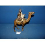 A cold painted Bronze of a camel with rider in the style of Franz Bergman,