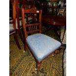 An Edwardian Mahogany framed Nursing Chair having carved top rail and spindles to the back rest,