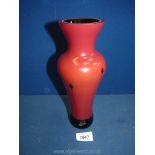 A heavy red glass vase with darker glass interior lining, 10'' tall.