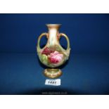 A Royal Worcester baluster shaped footed Vase with two handles decorated with pink roses with