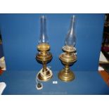 Two brass oil lamps, one being converted to electric the other with double wick.
