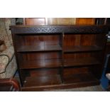 A 1930/40's floor standing dark Oak Bookcase having a carved frieze and adjustable shelves,