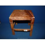 A small cowhide covered Stool with burn cross marks to legs, 11 3/4" tall x 10" square approx.