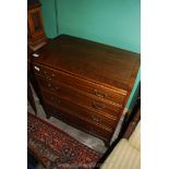 A compact Mahogany Chest of four long Drawers having brass drop handles and standing on splay