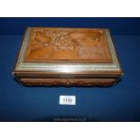 A carved jewellery Box with depicting a man sitting with inlay surround, green velvet interior,