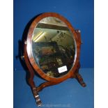 A small oval swing dressing table Mirror, 14 1/2'' tall.