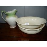 A Western wash bowl and jug in cream and another wash bowl.