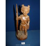 An ethnic Carving of a man with a spear, 16'' tall.