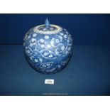 A large Pumpkin shaped oriental lidded jar with white prunus decoration on blue ground, 10'' tall.