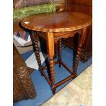 A 1930/40's Oak occasional Table standing on mirrored twist legs joined by a perimeter stretcher,