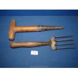 A wrought iron Ash wood handled gardener's hand fork and seed-planting dibber.
