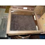 A sloping glass topped display Case, 18'' x 21 1/2'' x 3 1/2'' to 5'' deep.