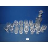 A cut glass decanter with two brandy balloons, four sherry glasses, nine small wine glasses etc.