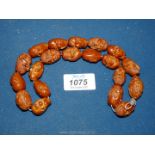 A string of oriental carved Lohan Buddha prayer beads