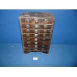 A wooden Jewellery box with eight drawers and floral and fleur de lys designs,