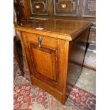 An early 20th Century oak purdonium/coal storage cabinet having a raised and fielded front panel