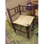 An appealing Arts and Crafts Oak framed carver Armchair having a woven seagrass seat,