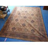 A large cream ground bordered and patterned wool rug/carpet. Approx 9ft x 13ft.