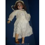 A large Armand-Marseille Bisque doll with open and close eyes, brown hair, marked 390 R,