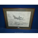 A framed and mounted Print taken from a pencil drawing of a Lancaster flying over a farmstead,