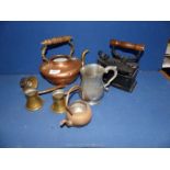 A copper teapot (lid missing), two brass measures, an antique cast clothes iron, door stop,