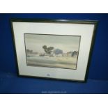 A framed and mounted Watercolour depicting an Estuary scene with boats, figures and houses.