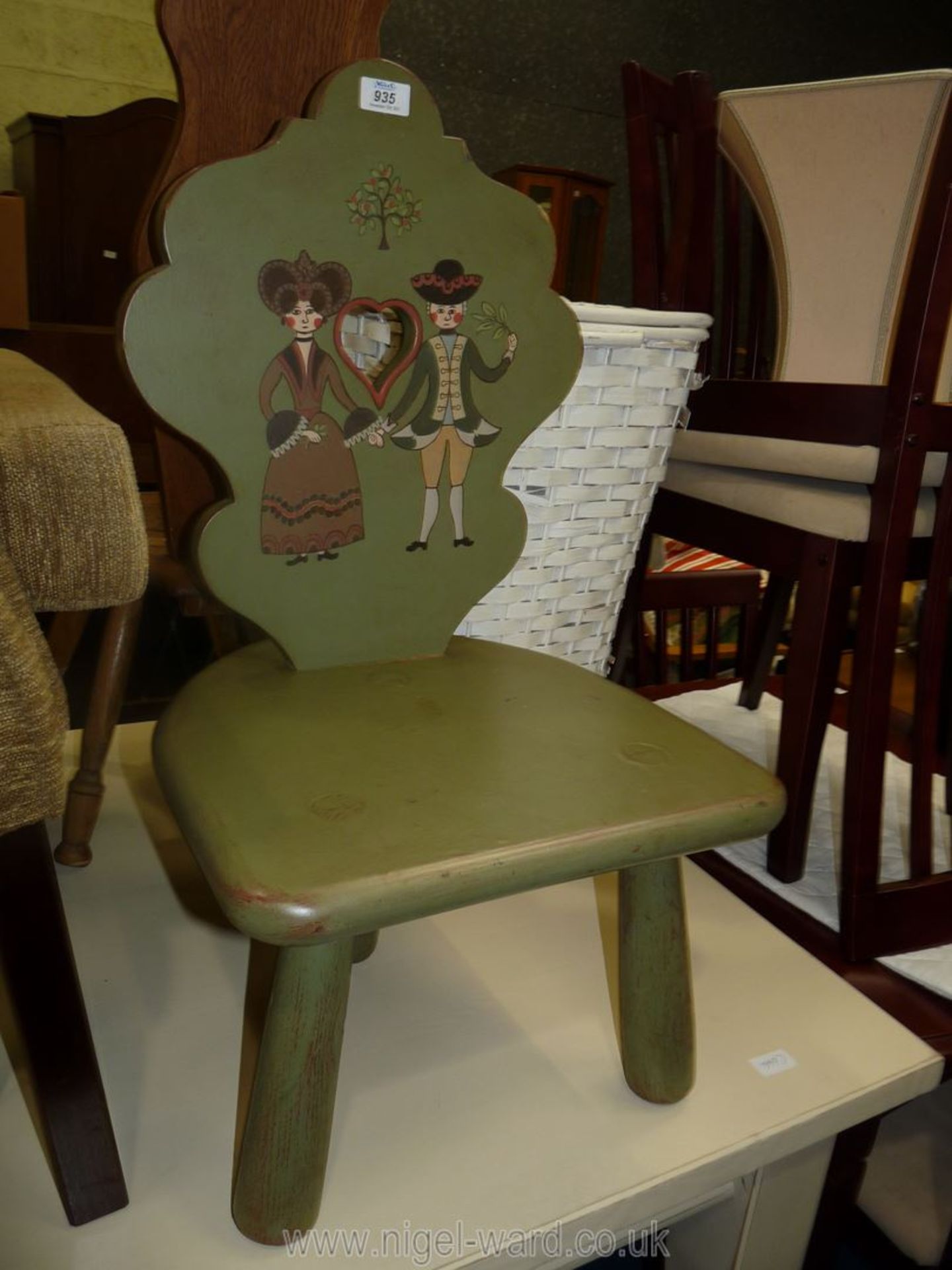 A three legged painted children's chair.