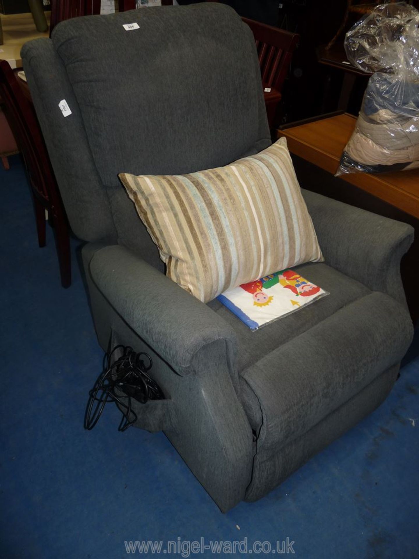 An electric reclining chair in blue/grey upholstery with controls.