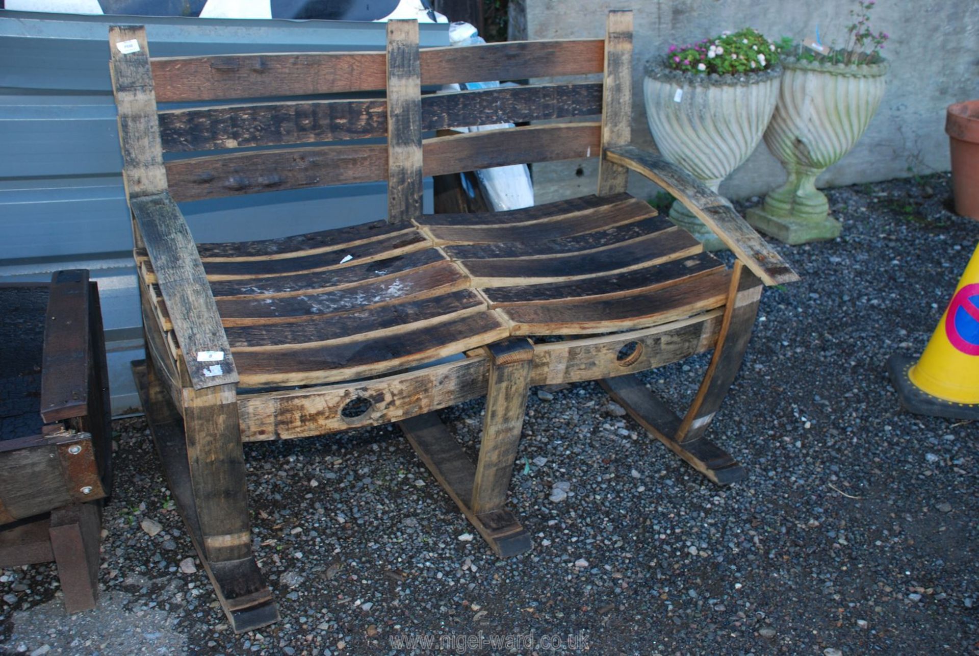 Two seater garden rocking bench made from old whisky barrels.