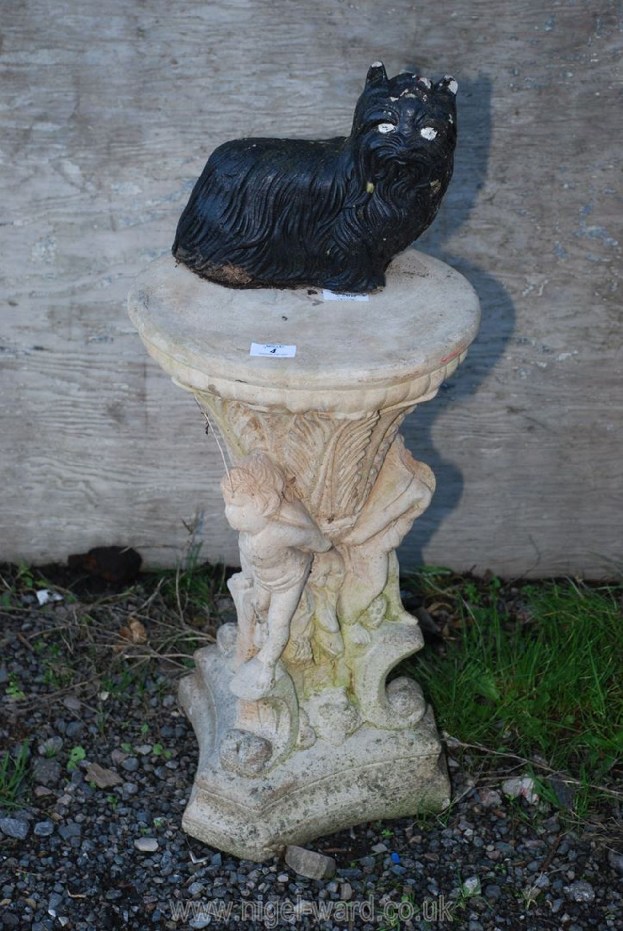 Concrete garden plant stand with three cherubs to the base, a/f and a small concrete Yorkie dog.