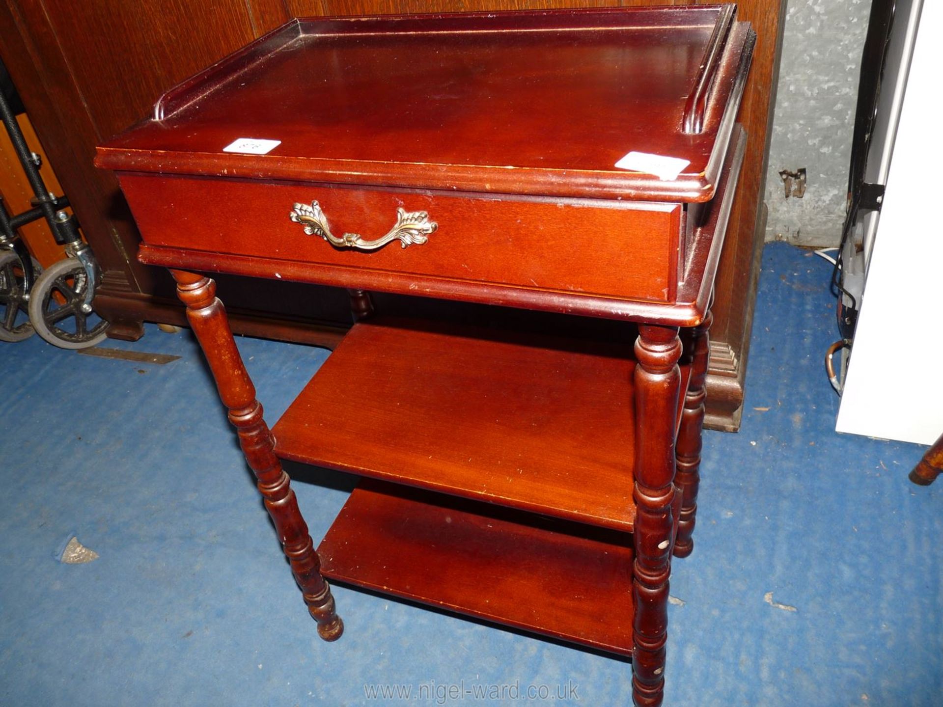 A darkwood hall table with two shelves and drawer, 18 1/2" wide x 1 3/4" deep x 27" high.