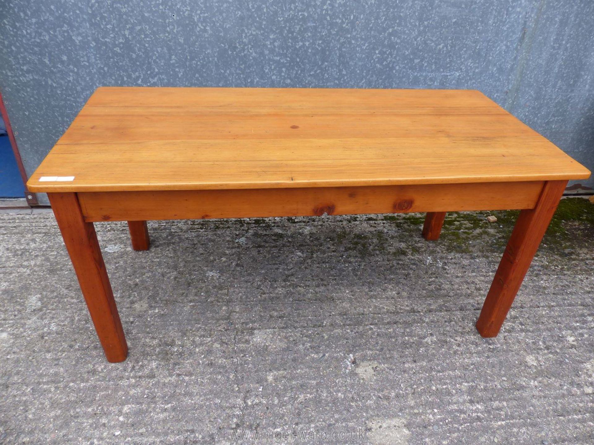 A stained pine dining table, 60" long x 29" wide x 28 1/2" high.