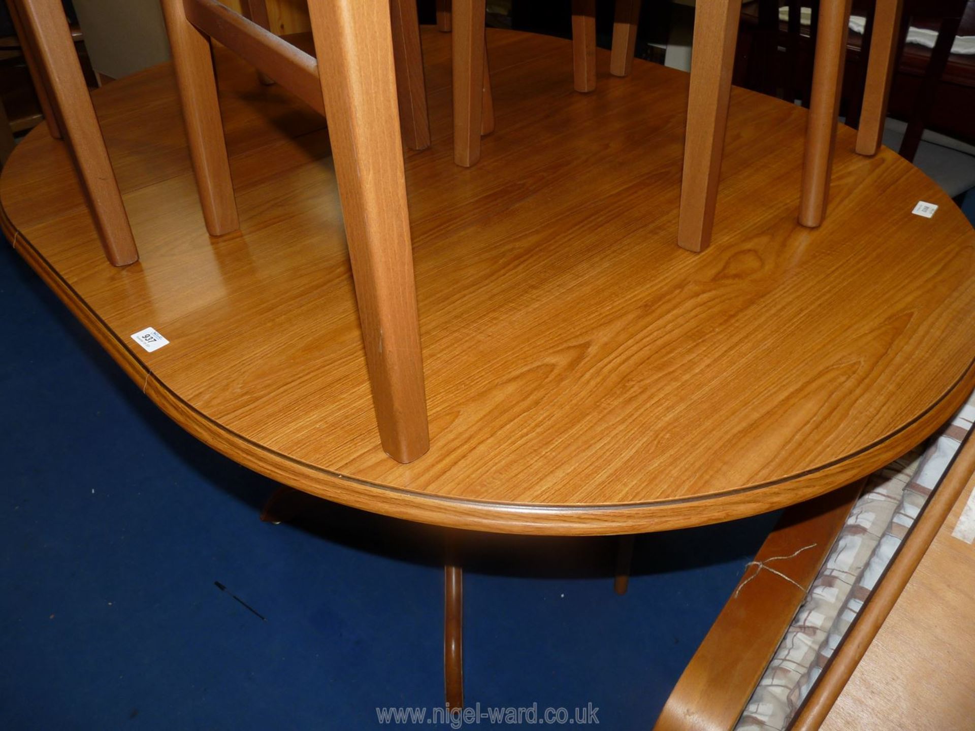 An extending dining table on single pedestal base, 56" long (extended) x 40 1/2" wide x 30" high.