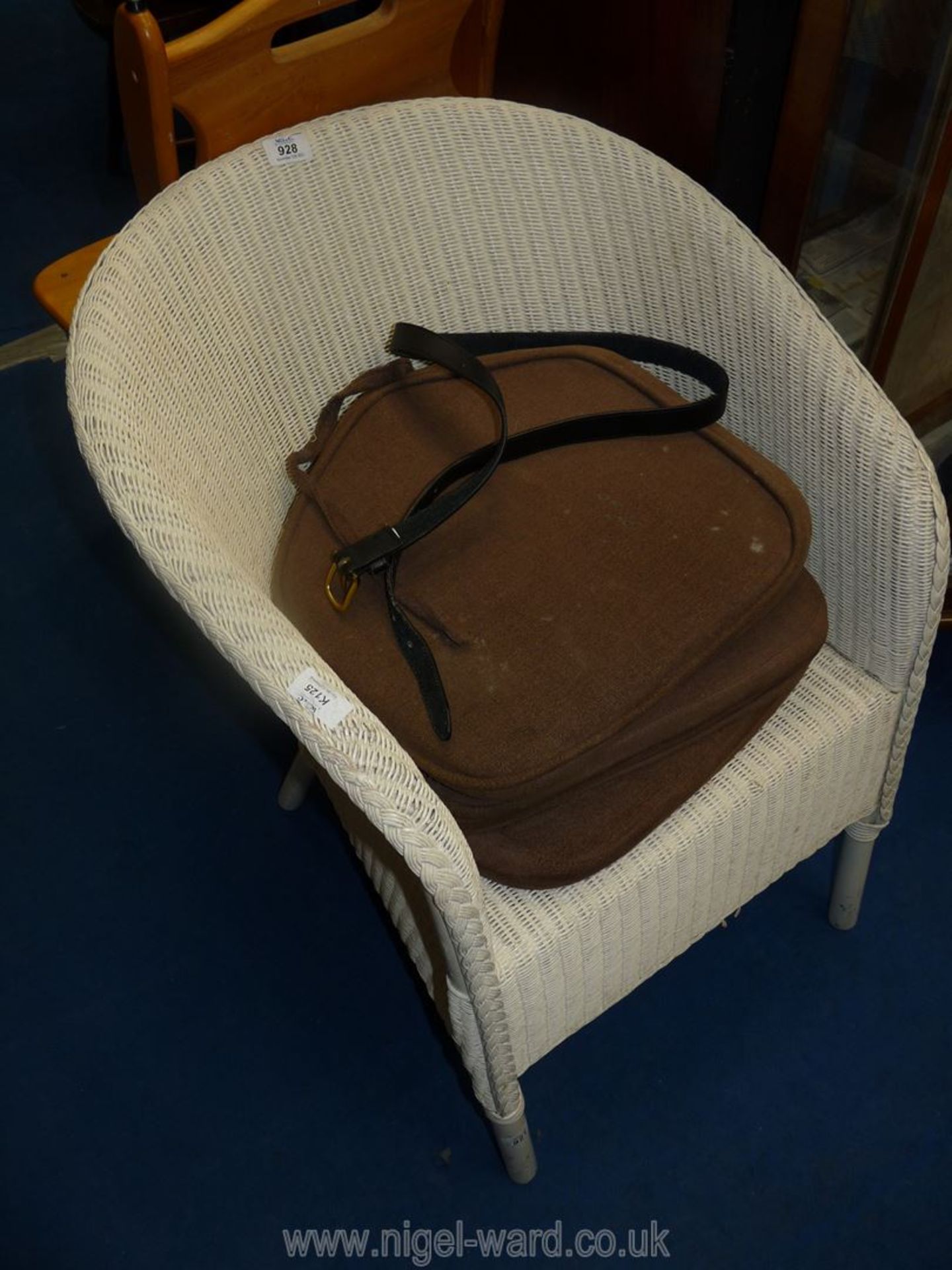 A Lloyd Loom chair, cushion pads and belt.