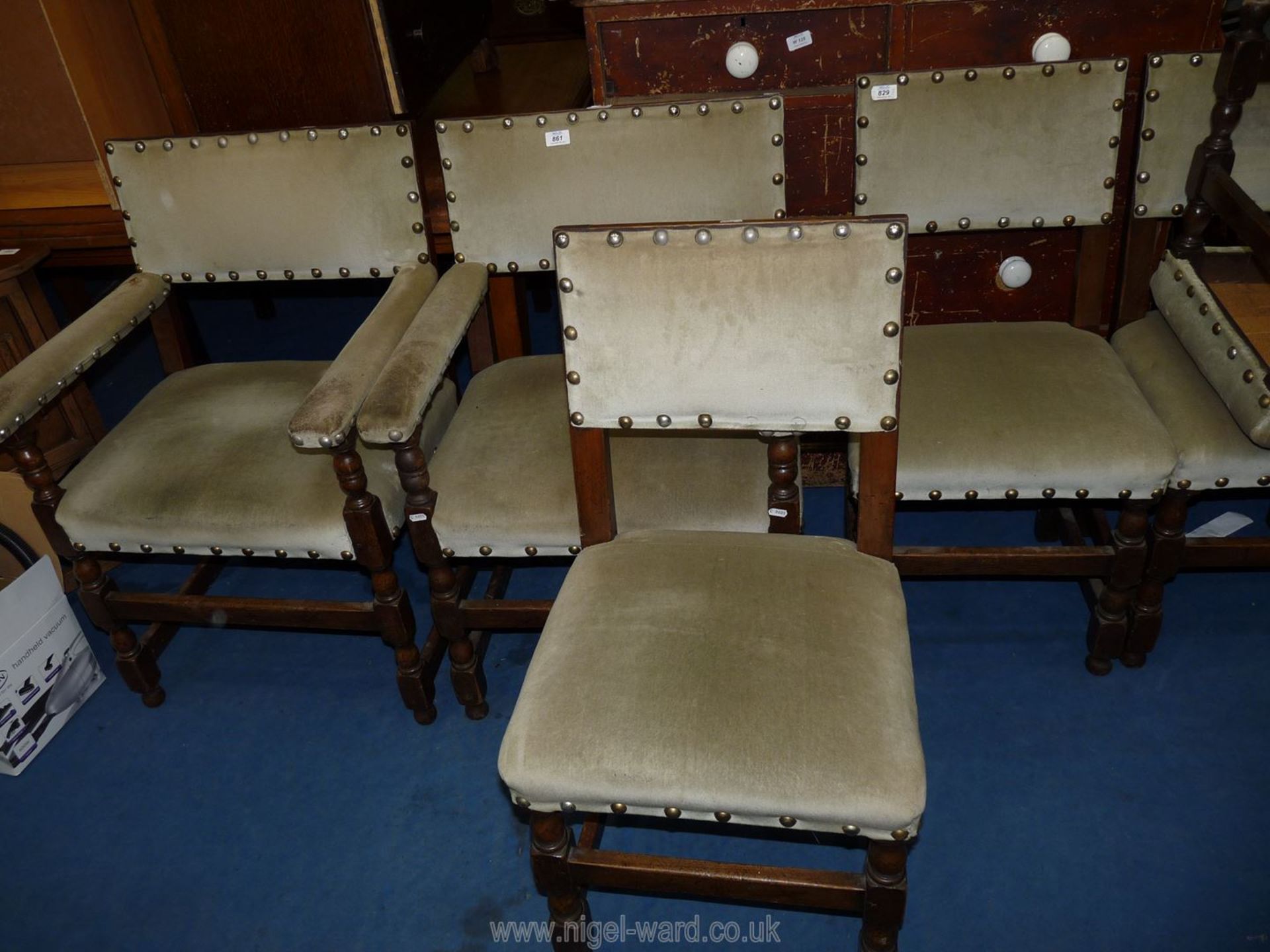 A set of eight dining chairs including two carvers with green draylon upholstery.