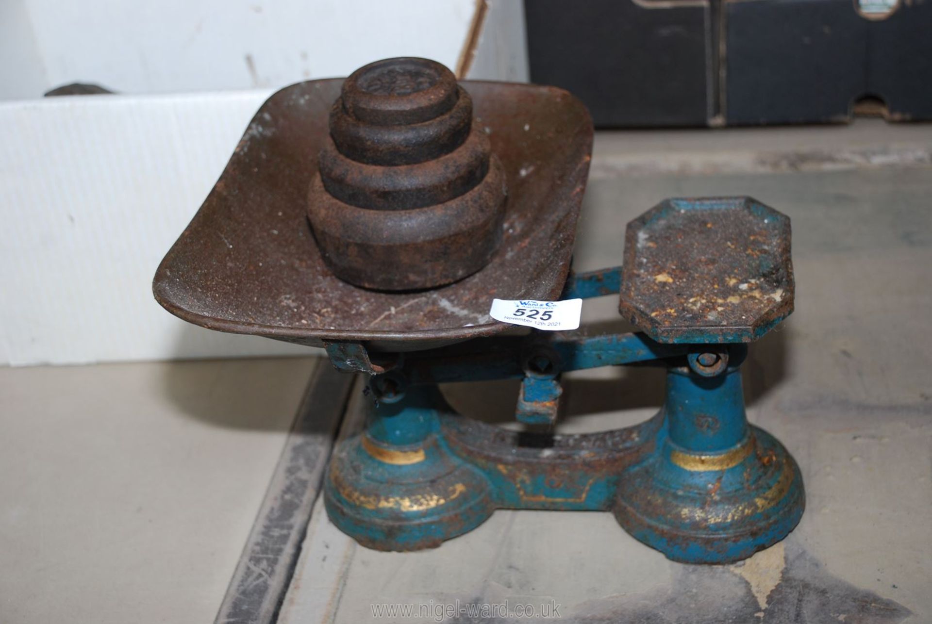 A set of kitchen scales and weights.