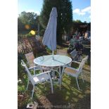 Glass topped patio table 4' diameter and four folding chairs, parasol and base.