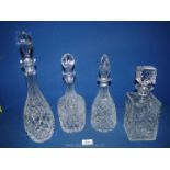 Four cut glass decanters including Thomas Webb conical shape, square shaped etc.