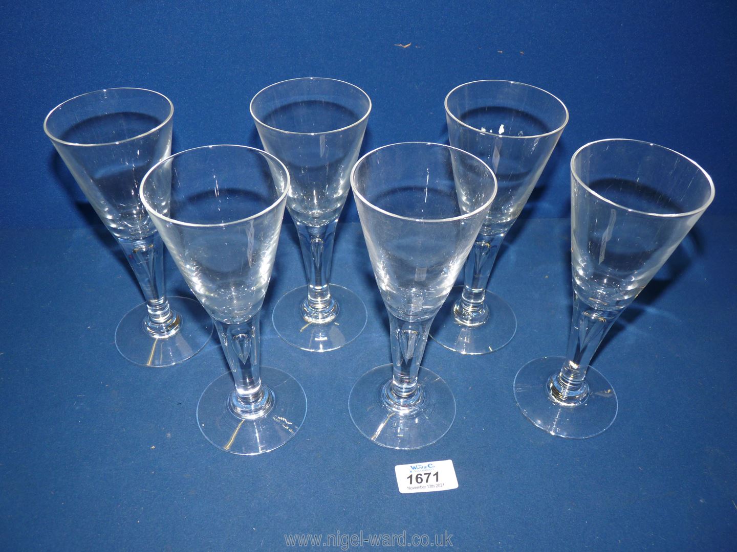 Six funnel shaped wine glasses with teardrop detail within the stems.