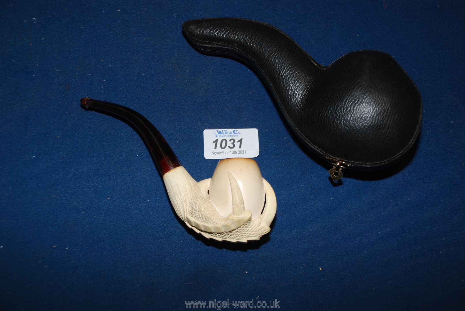 A lovely vintage Meerschaum pipe carved as an eagles claw holding an egg in its original case.
