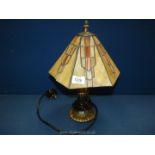 A Tiffany style lamp with various yellow geometric panels, (very much a/f), 14'' tall.