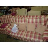 A three piece suite comprising sofa, two armchairs and footstool with red,