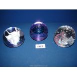 Three Caithness paperweights to include; pink champagne, snow orchid and transmission.