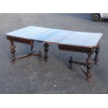 A stylish Oak extending Dining Table standing on turned and ??? legs united by a pair of barrel