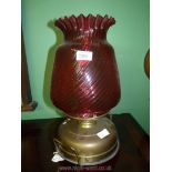 An unusual Church oil heater/lamp with two handled brass base standing on three feet,